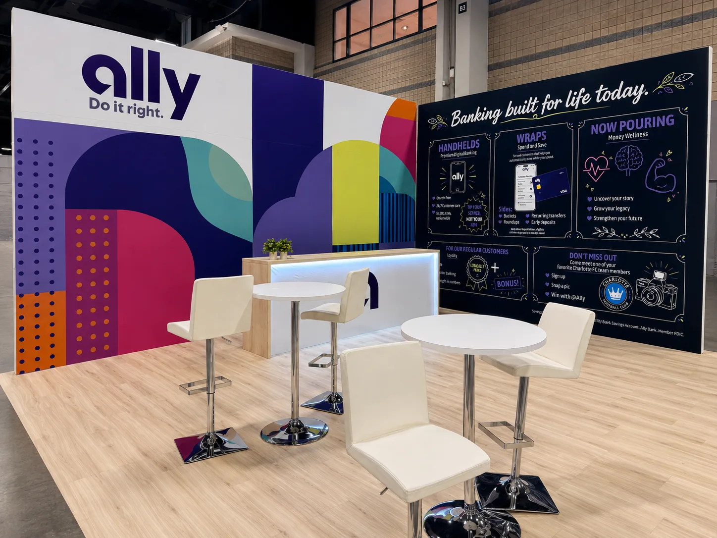Completed large branded trade show exhibit with overhead structure, illuminated graphics, counters, seating, and displays