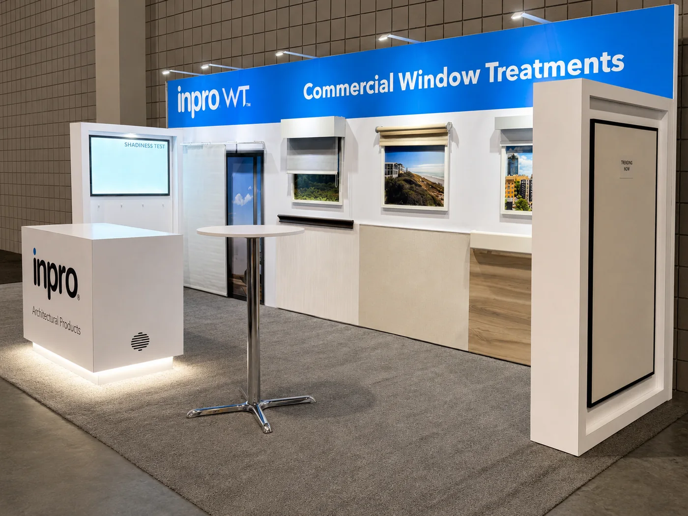 Completed Inpro commercial window treatments trade show exhibit with illuminated counter and display walls