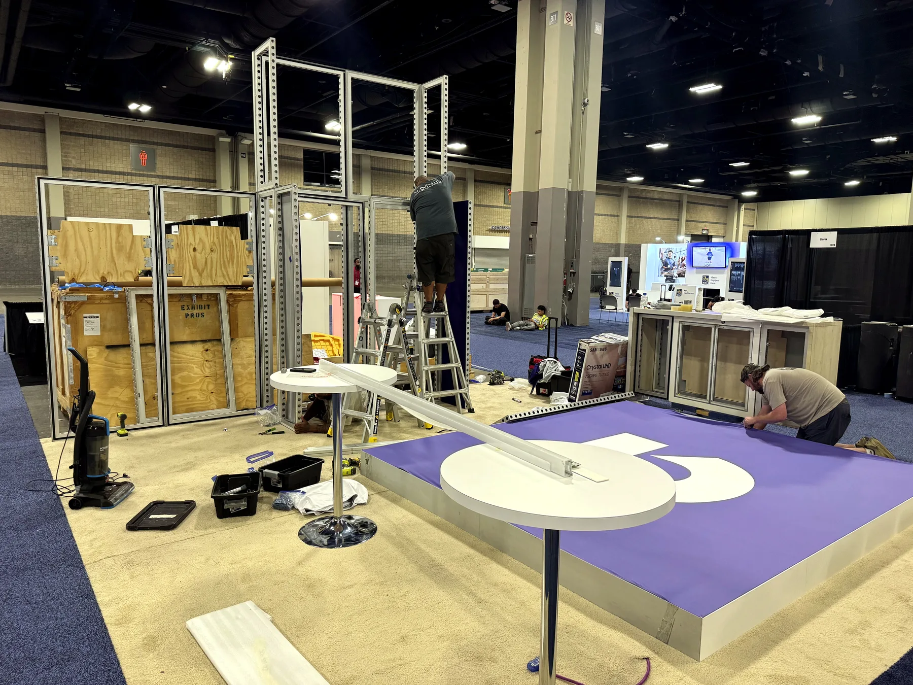 Exhibit installation crew working together during a trade show booth build